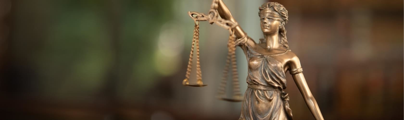golden justice is blind statue with scales 